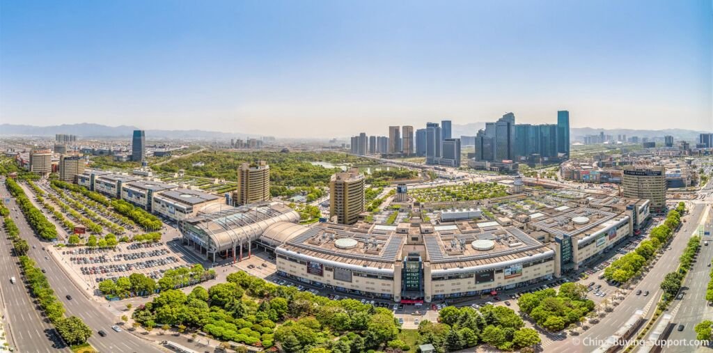 Aerial view of Yiwu International Trade City (Yiwu Futian Market), Zhejiang, China—wholesale blocks, circular roofs, car parks, central park and towers.