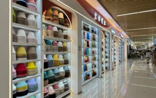Yiwu International Trade City hat factory's showroom with floor-to-ceiling shelves of bucket hats in many colors; factory showroom in District 4