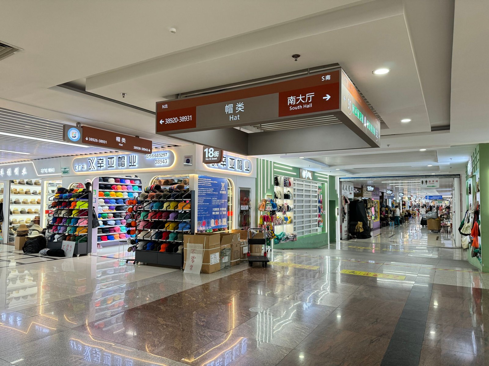 Overhead “Hat” signage at No. 18 Street, corridor of Yiwu International Trade City’s hat section extending toward 19–30 streets