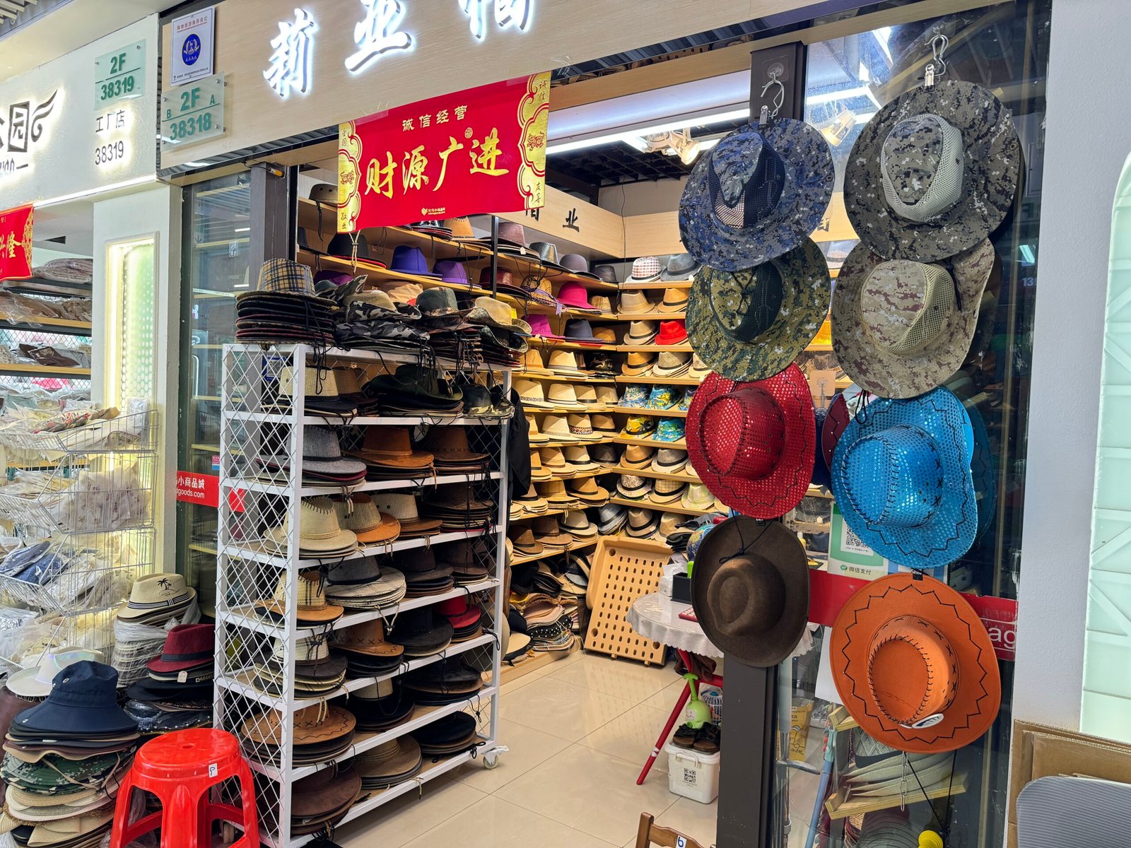 Yiwu wholesale market cowboy hat shop with straw and faux-leather western hats, mesh styles and fedoras