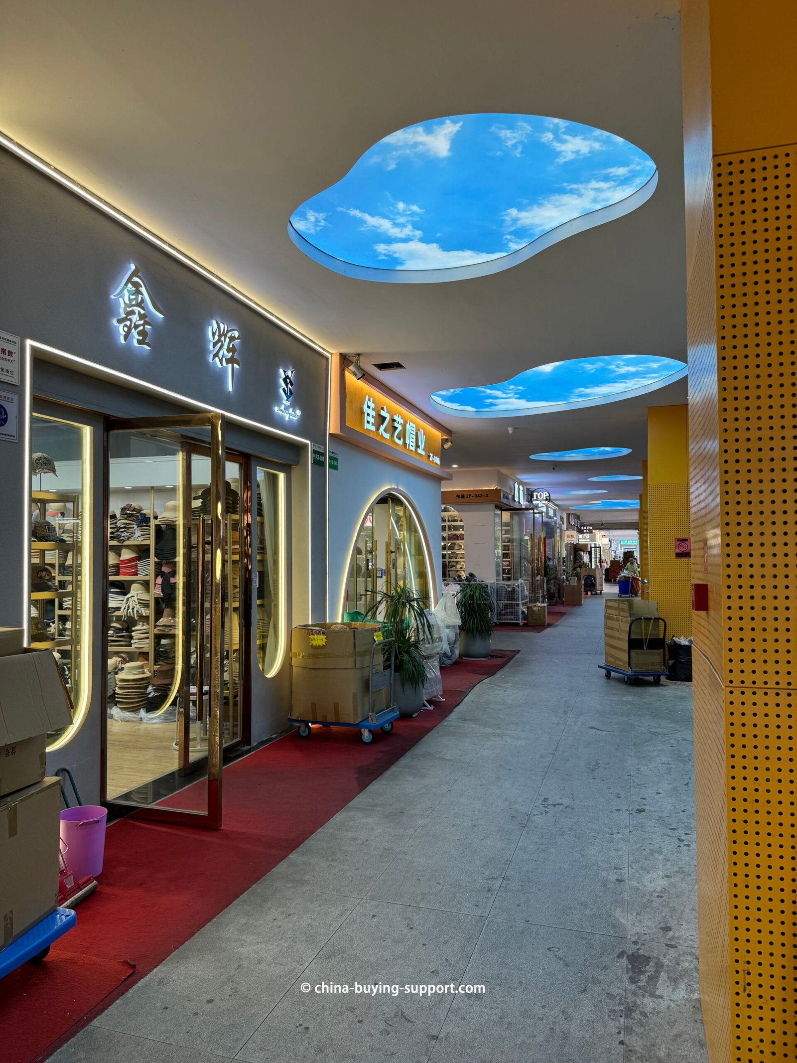 Yiwu market Gate 84 East Attached Building corridor with hat shops, cloud ceiling panels, red carpet