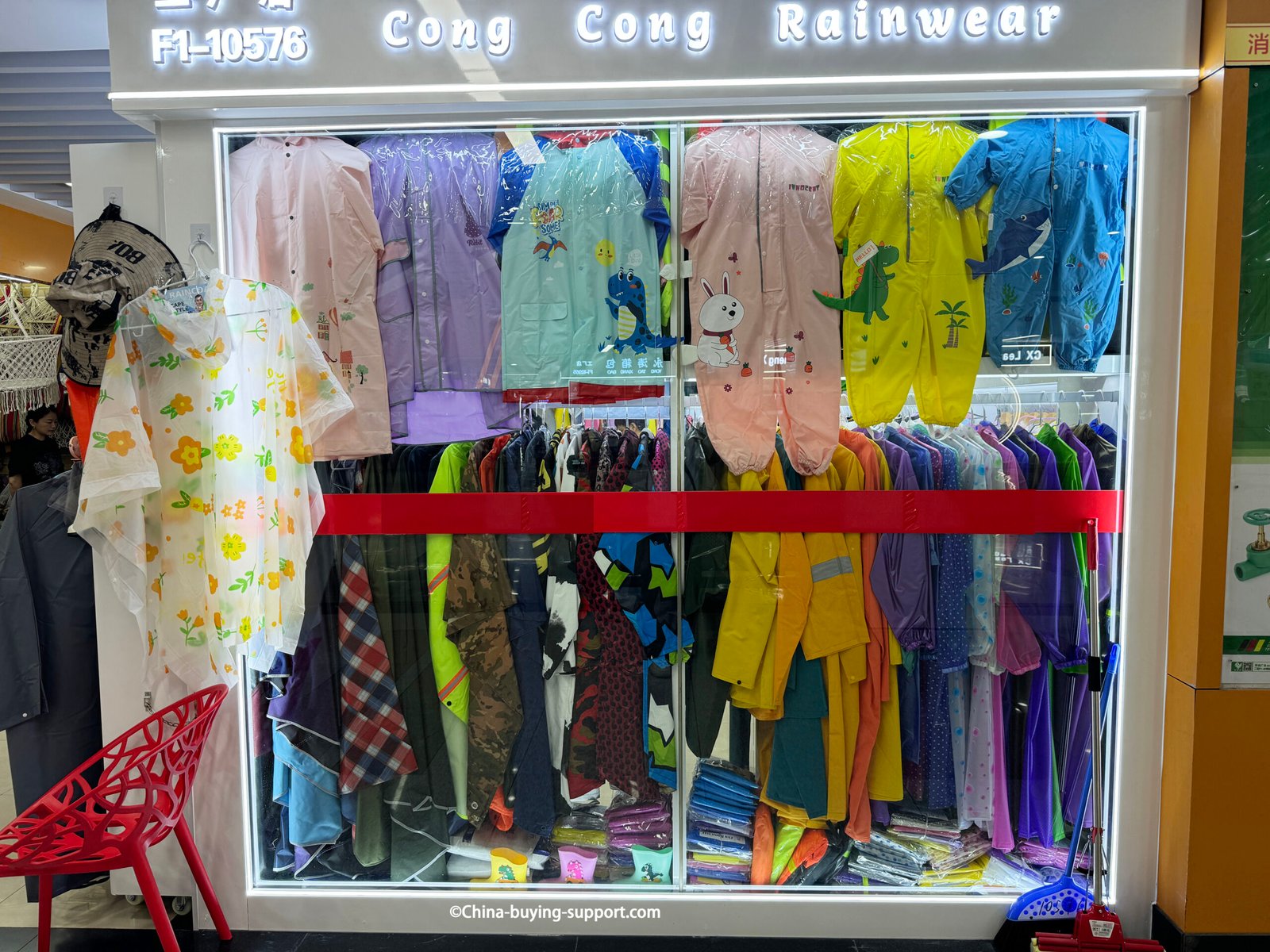 yiwu district 2 rainwear window display with kids cartoon raincoats, full-body suits, adult rain jackets, clear floral ponchos