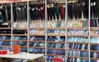yiwu premium umbrella showroom sample wall with long-handle and folding umbrellas in patterned sleeves