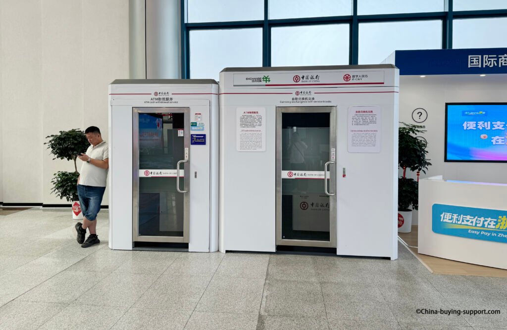 Bank of China ATM cash withdrawal and self-service currency exchange kiosks at Yiwu International Trade City West Gate Hall, providing 24-hour access for international card users and foreign currency exchange.