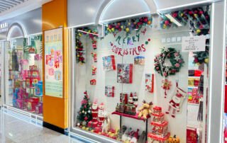 Christmas-themed gift packaging display at Yiwu International Trade City Zone 2, featuring festive boxes, Santa Claus figures, holiday wrapping, and decorative wreaths from a Chinese supplier.