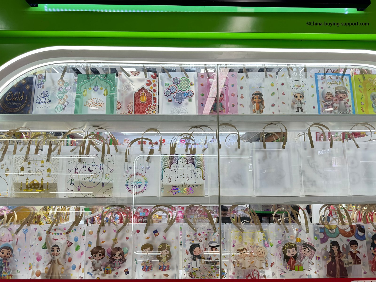 Eid and Ramadan themed PVC gift bags displayed at Yiwu International Trade City District 2 gift packaging market, featuring Islamic designs, cartoon characters, and colorful festive patterns.