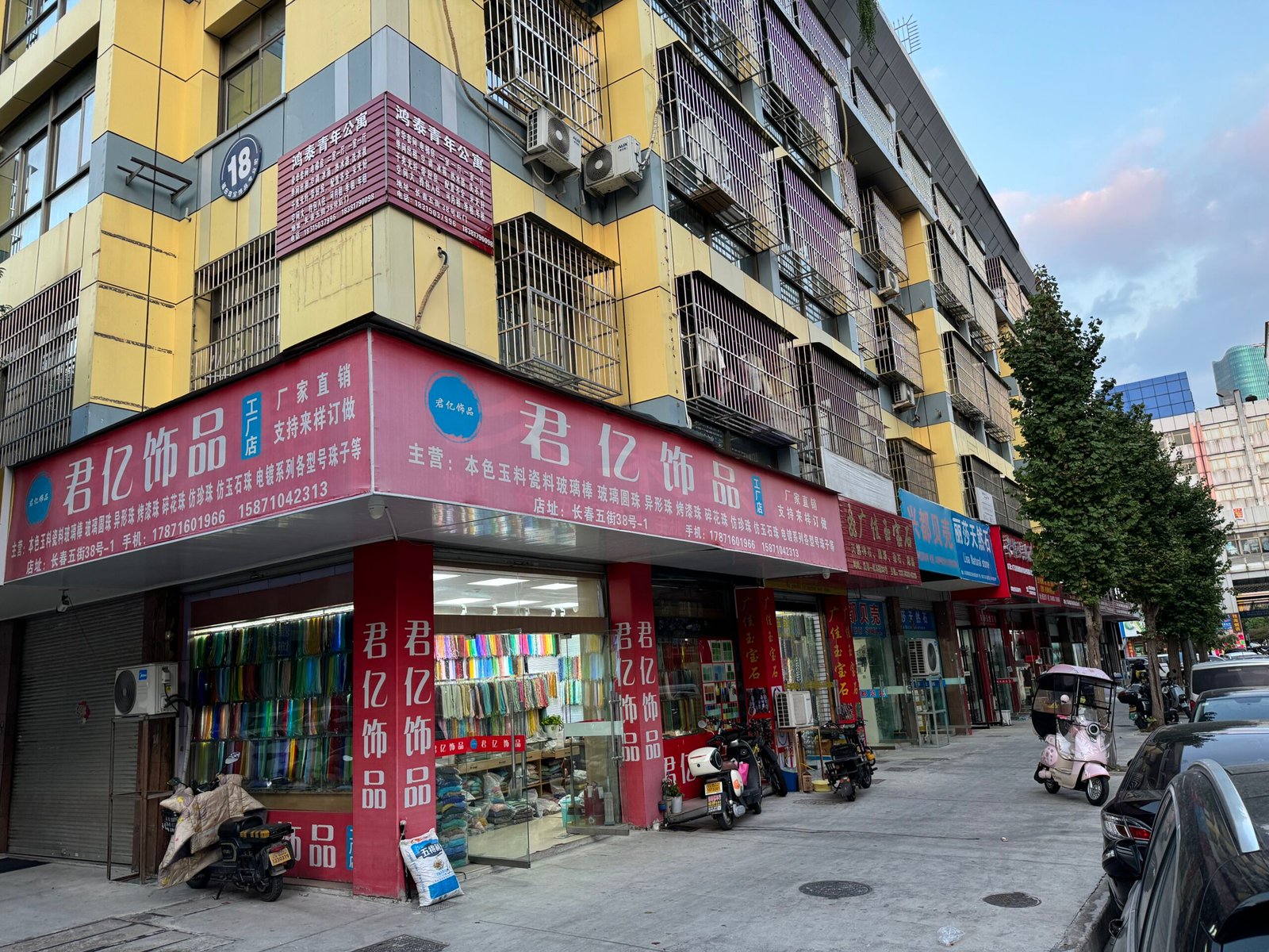 Junyi Jewelry shop window packed with colorful bead strands on Changchun Street, Yiwu—agate, quartz, crystal, glass, seed beads