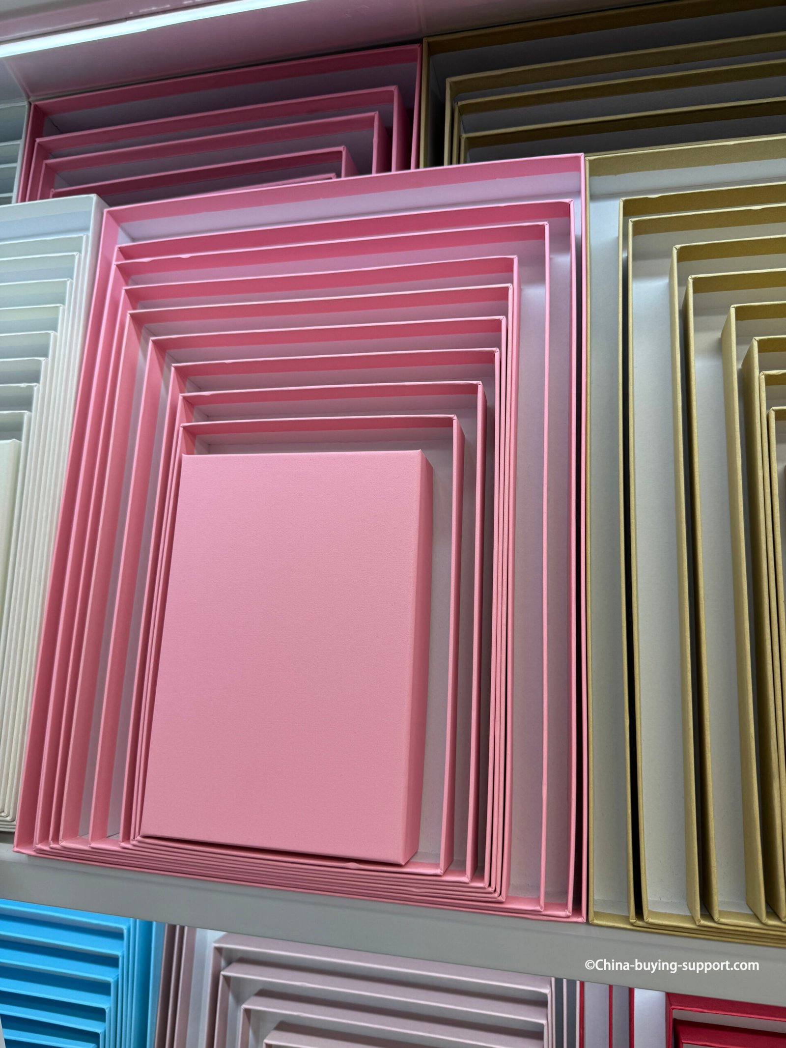 Close-up of pink and gold ten-piece nesting gift box sets from a packaging supplier in Yiwu International Trade City District 2, showing detailed layered box design for retail and gift packaging.