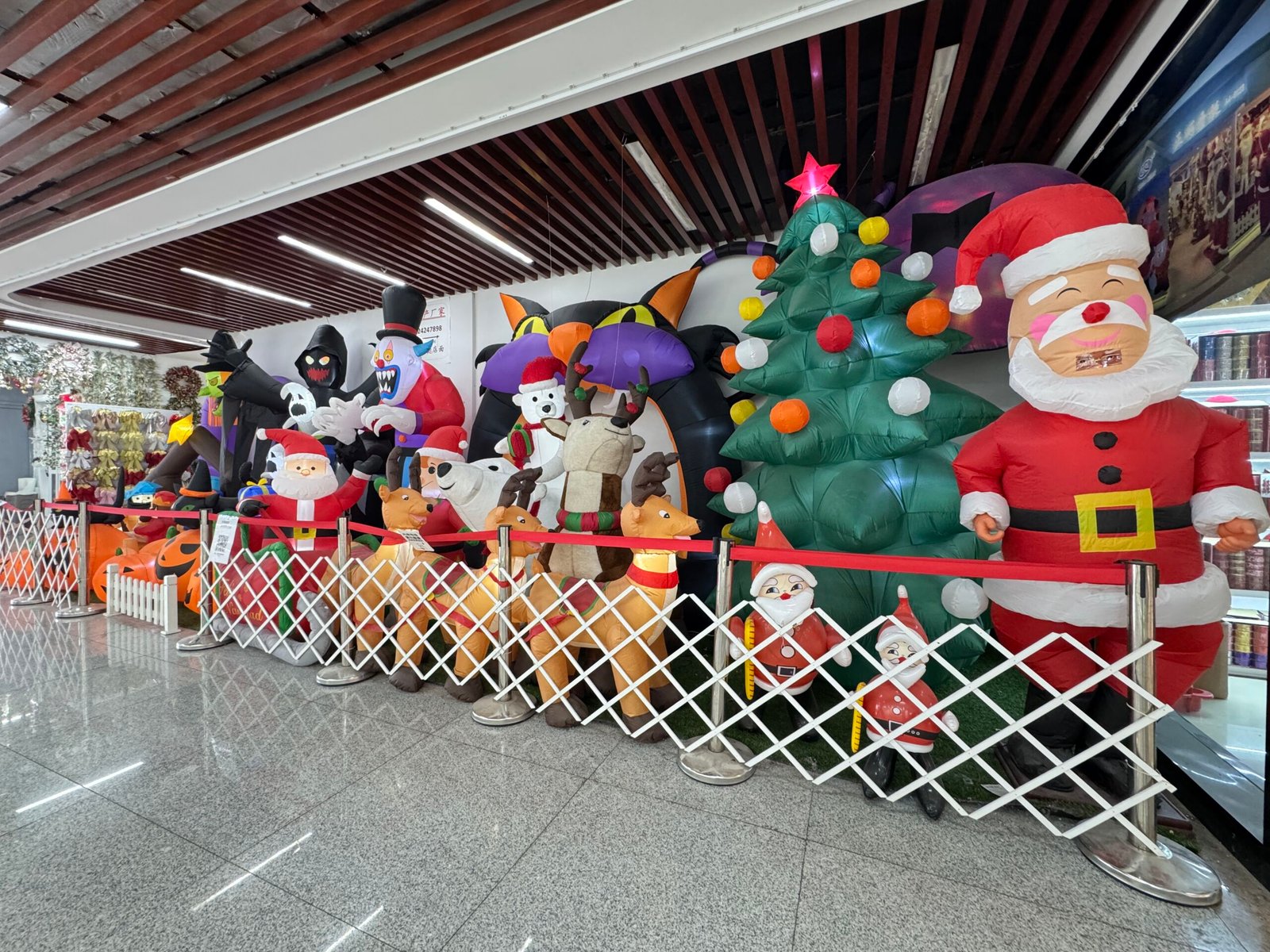 Giant Christmas inflatables including Santa, reindeer, polar bear and a big Christmas tree at a Yiwu wholesale decorations showroom