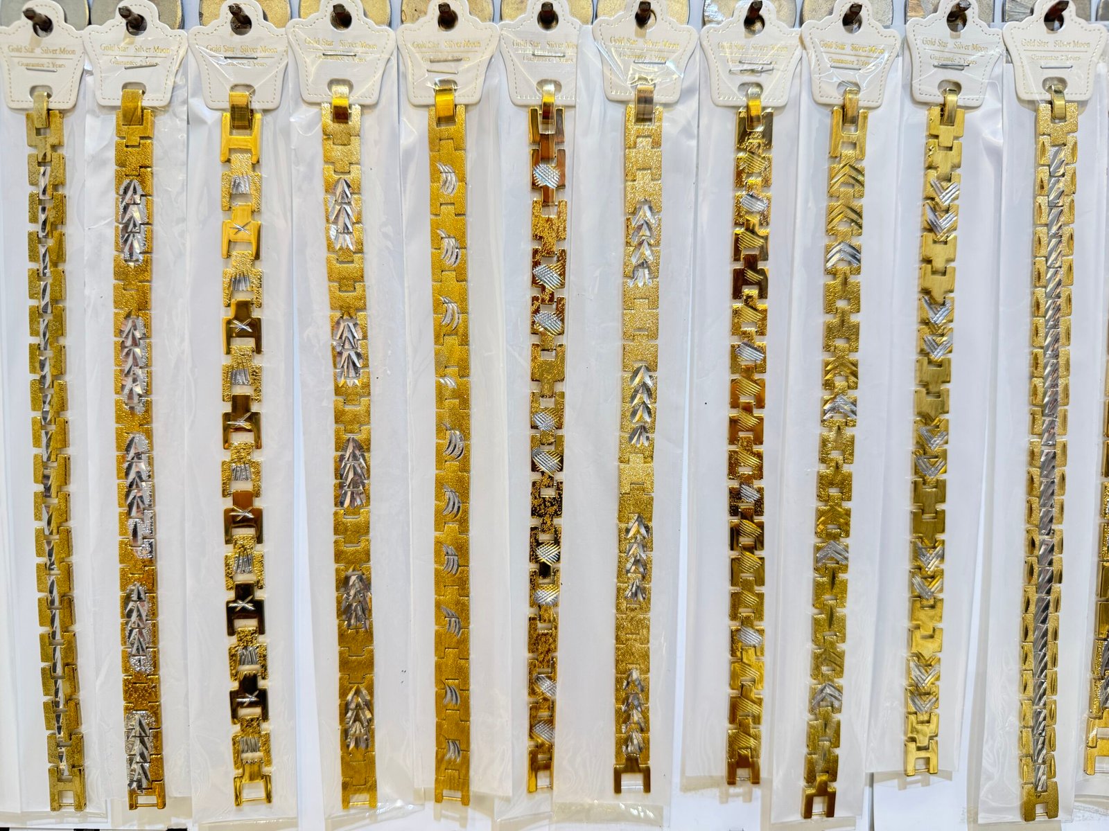 Close-up of copper gold plated bracelet chains in 7mm and 11mm widths for wholesale ready stock, in Yiwu Jewelry Market