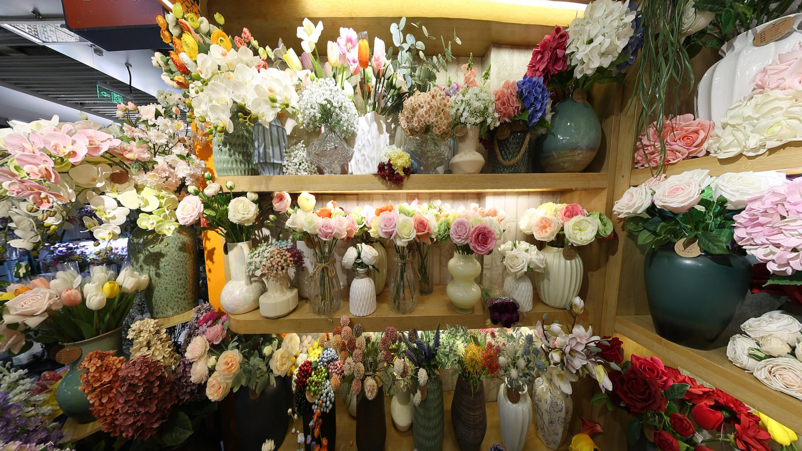 Inside a Yiwu Artificial Flower Wholesale Market shop with artificial flowers, bouquets, and floral decor