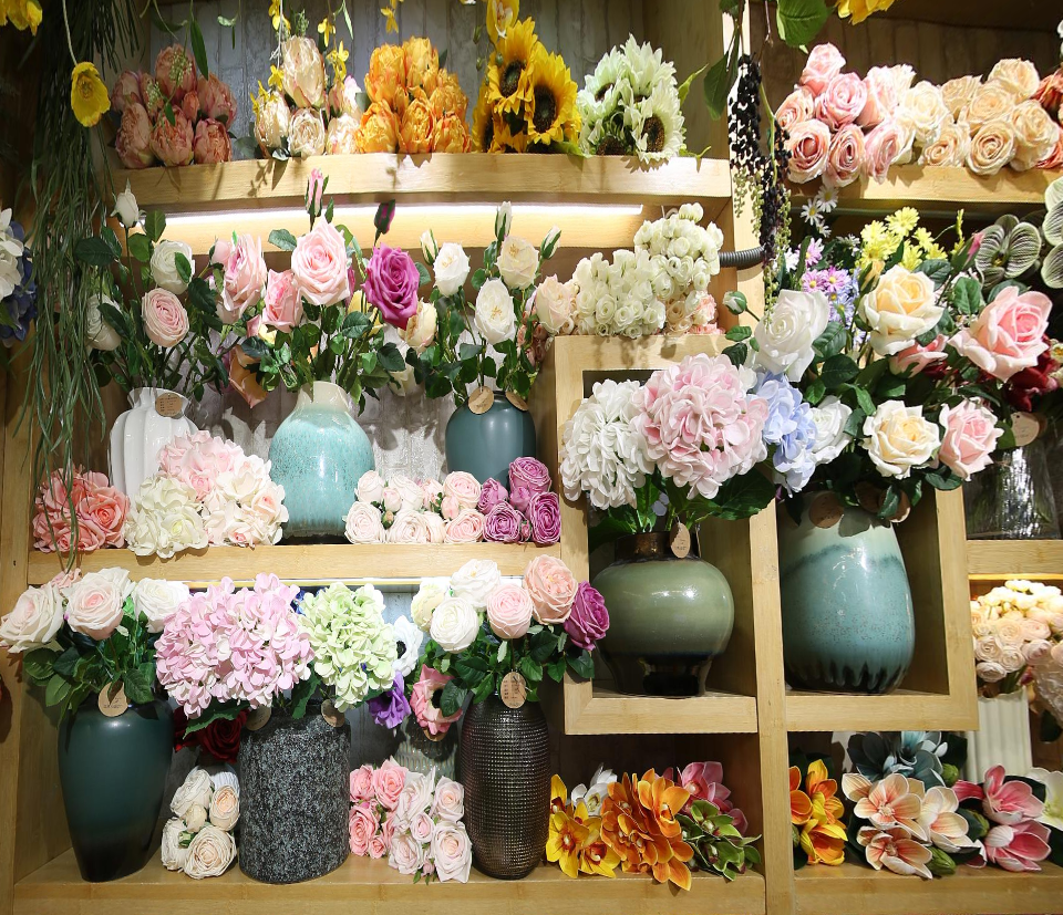 Artificial flowers and silk flower arrangements displayed in a Yiwu Artificial Flower Market wholesale shop