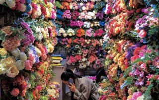 Wholesale artificial flower shop in Yiwu with staff preparing faux flower orders