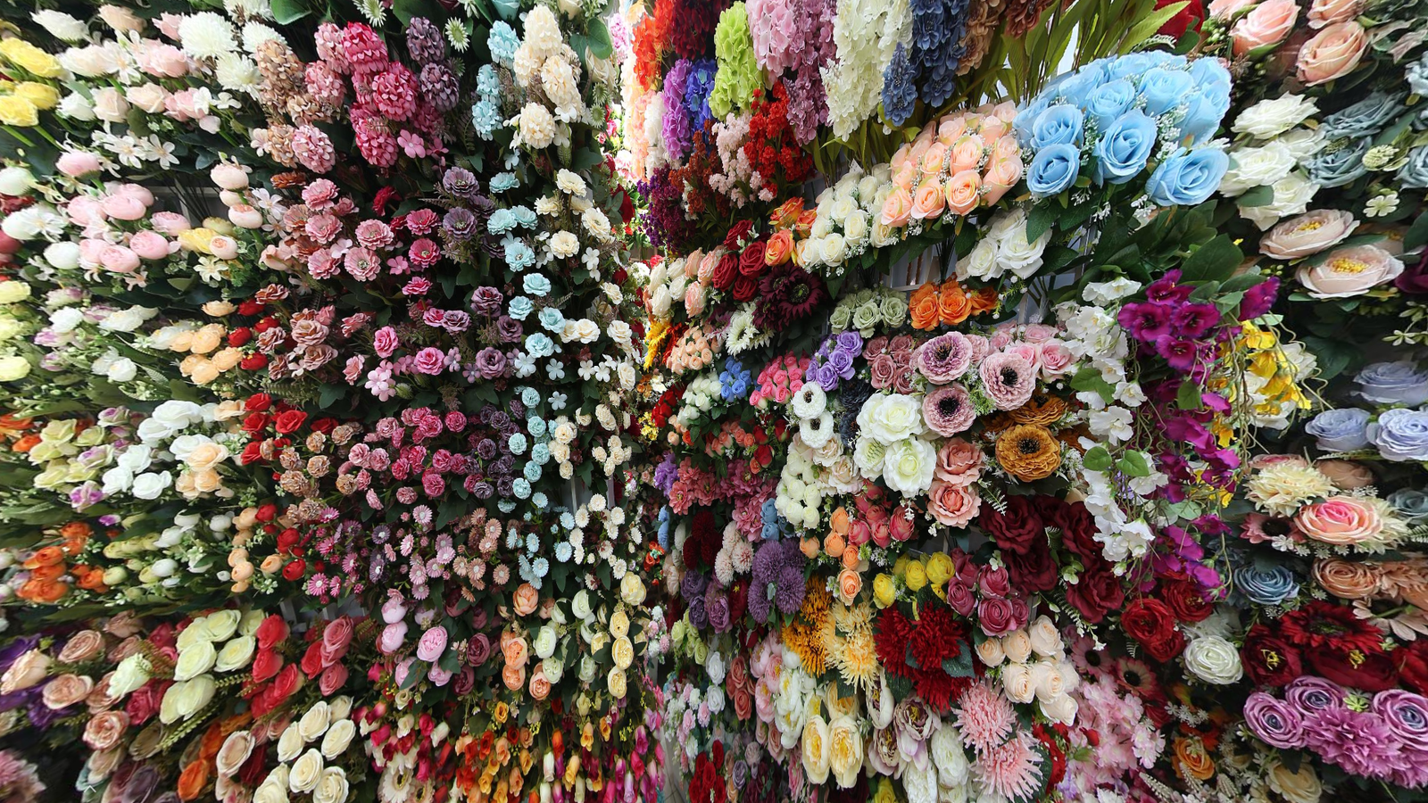 Artificial flower walls with hundreds of faux flower styles in Yiwu Artificial Flower Wholesale Market