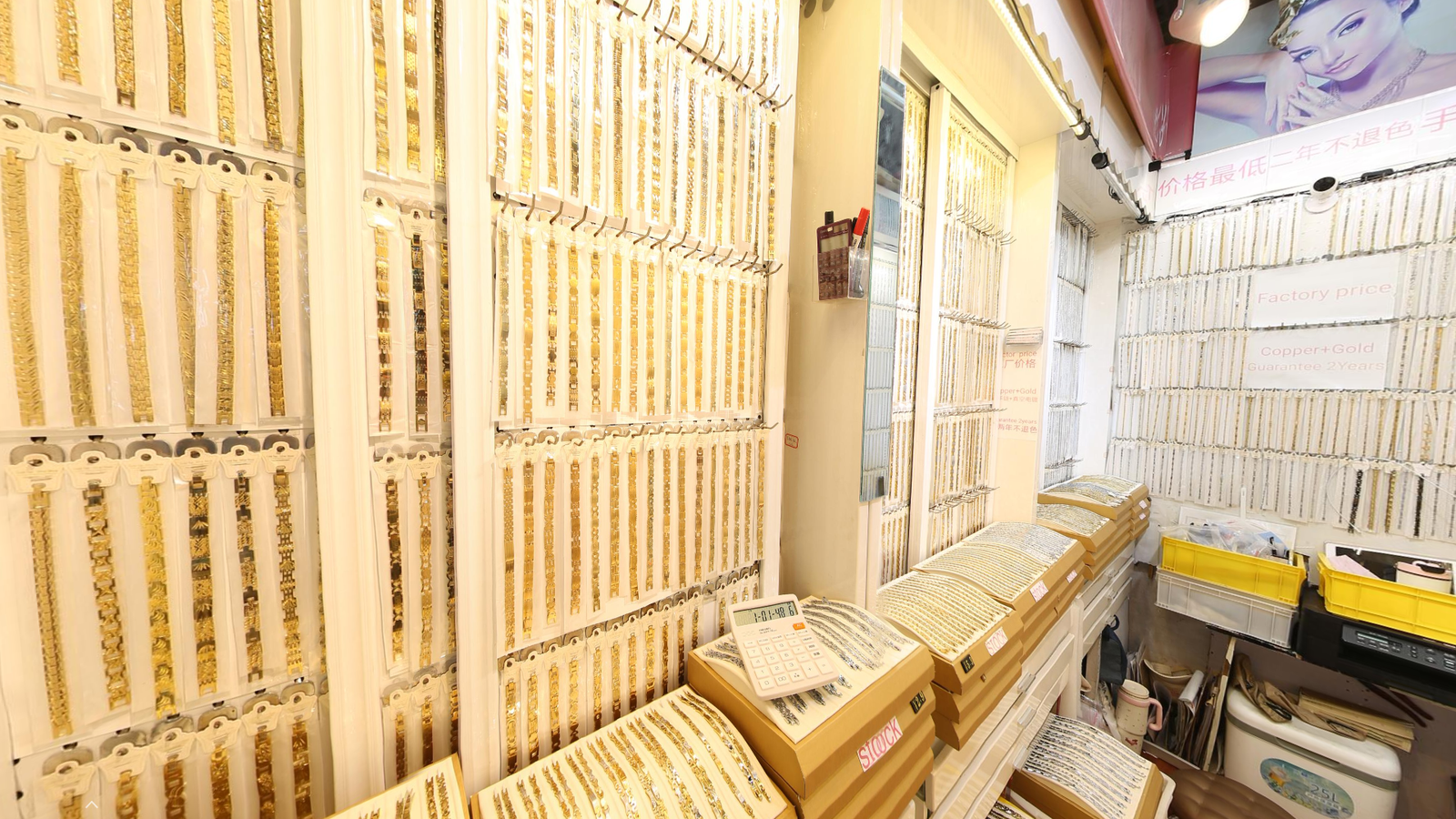 Copper gold plated bracelet wholesale display with ready stock at Yiwu International Trade City factory supplier booth, Photographed in Yiwu Jewelry Market.