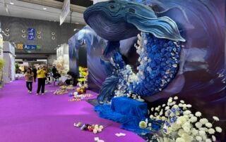 Blue whale ocean-themed wedding display with blue floral backdrop at Yiwu wedding market