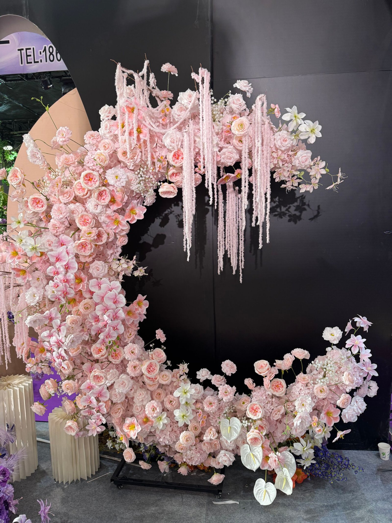 Pink crescent moon floral wedding backdrop with roses and orchids at Yiwu wedding market