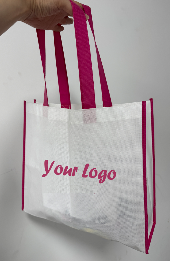 White non-woven shopping bag with magenta webbing handles and a single-color logo print