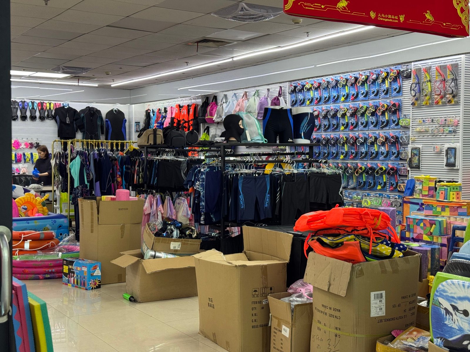 Swimwear and snorkeling gear shop in Yiwu Sports Market with goggles, wetsuits, and swim accessories