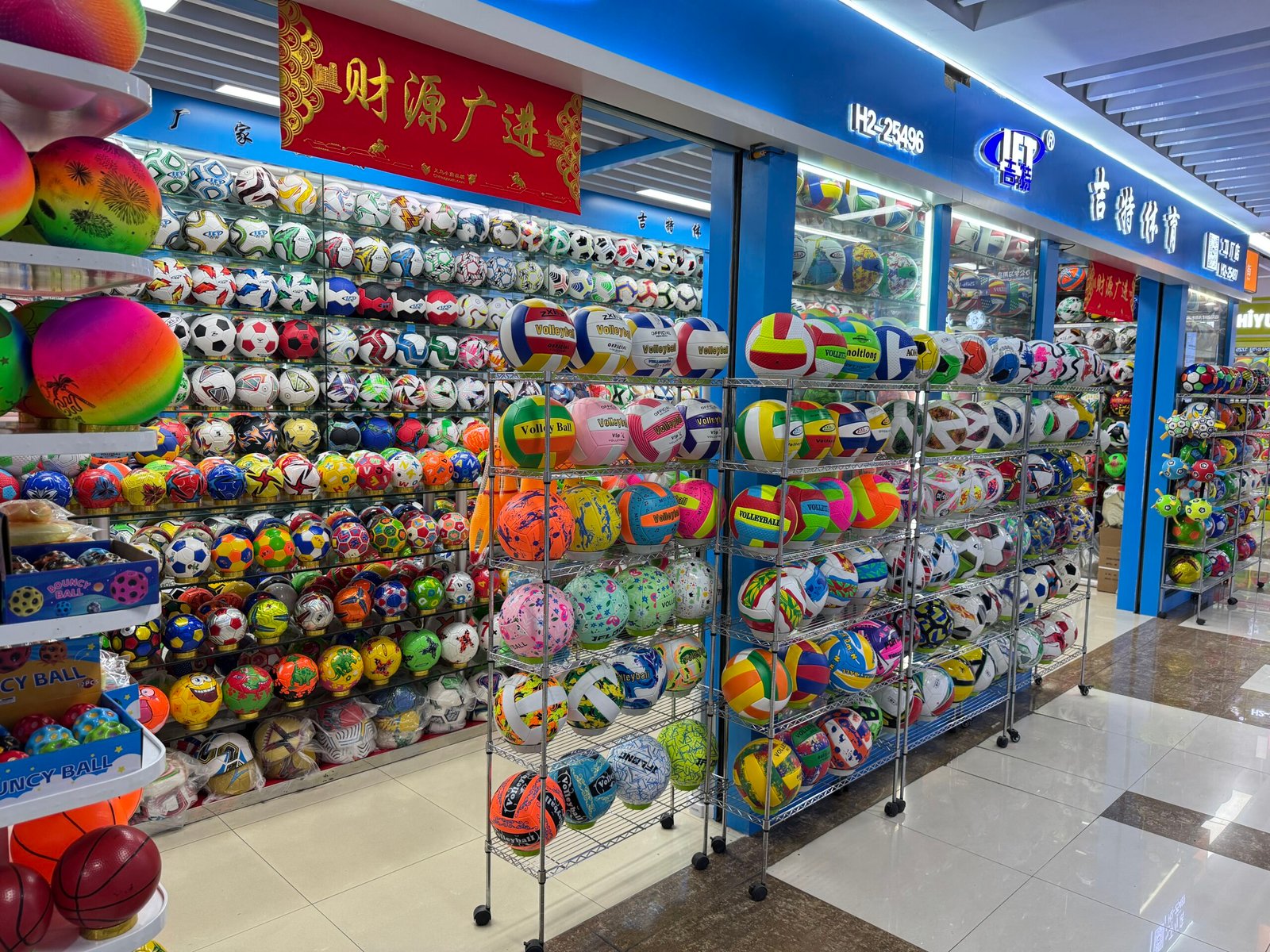 Wholesale sports ball shop in Yiwu Sports Market with footballs, volleyballs, and colorful training balls on display