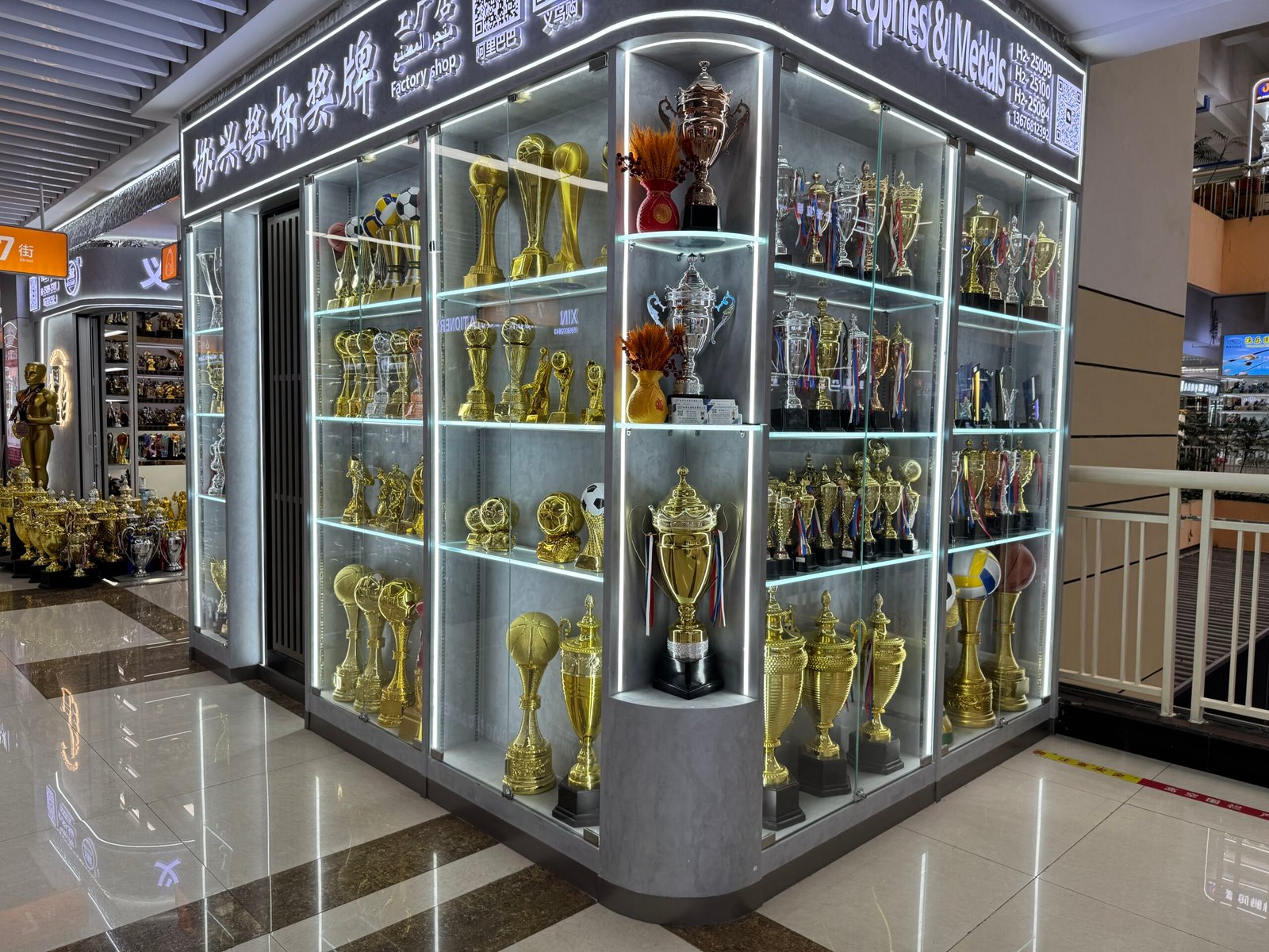 Sports trophies and award cups displayed inside a Yiwu wholesale market shop