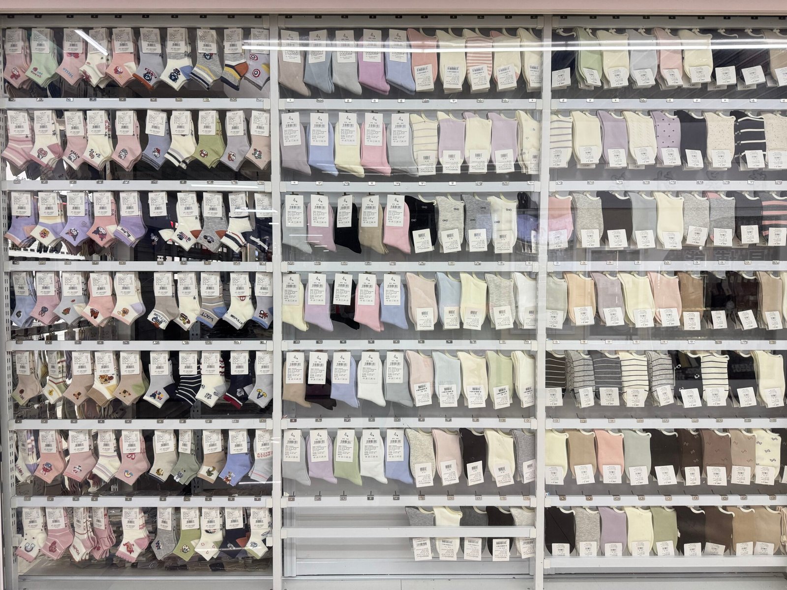 Long aisle of factory-direct sock suppliers and wholesale stores in the Yiwu sock market