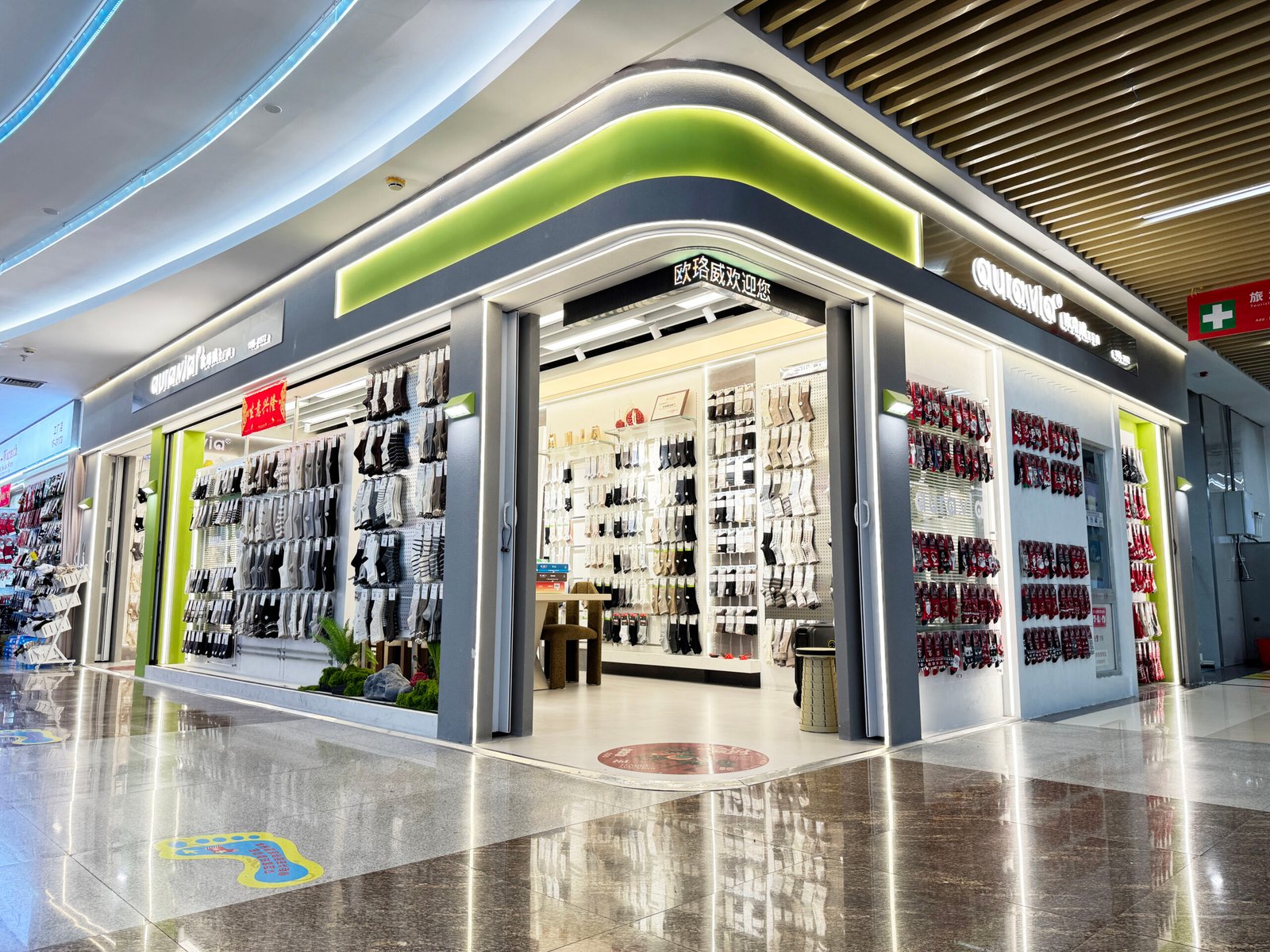 Corner sock supplier showroom with illuminated wholesale displays inside the Yiwu market